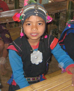 A young student in a remote Laotian village wears traditonal clothing.